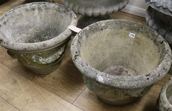 A pair of composition stone garden urns, W.50cm